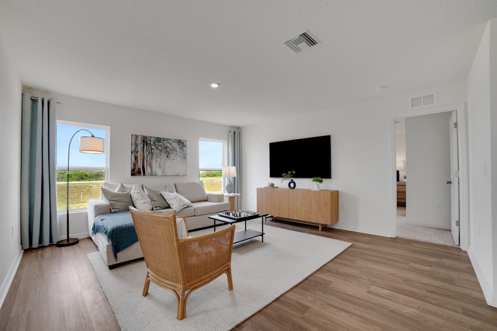 A living room with a wood floor.