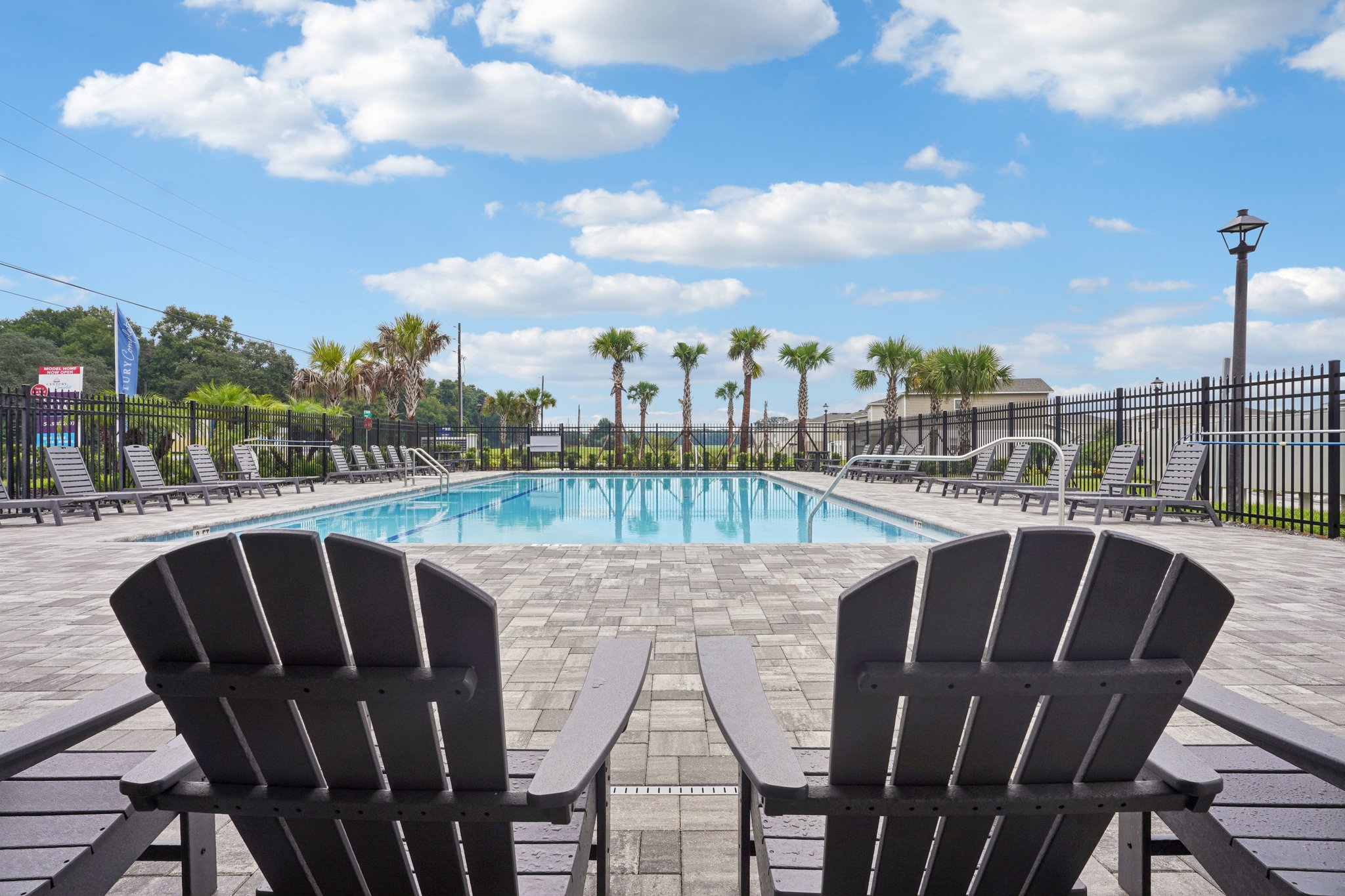 A pool with chairs around it.