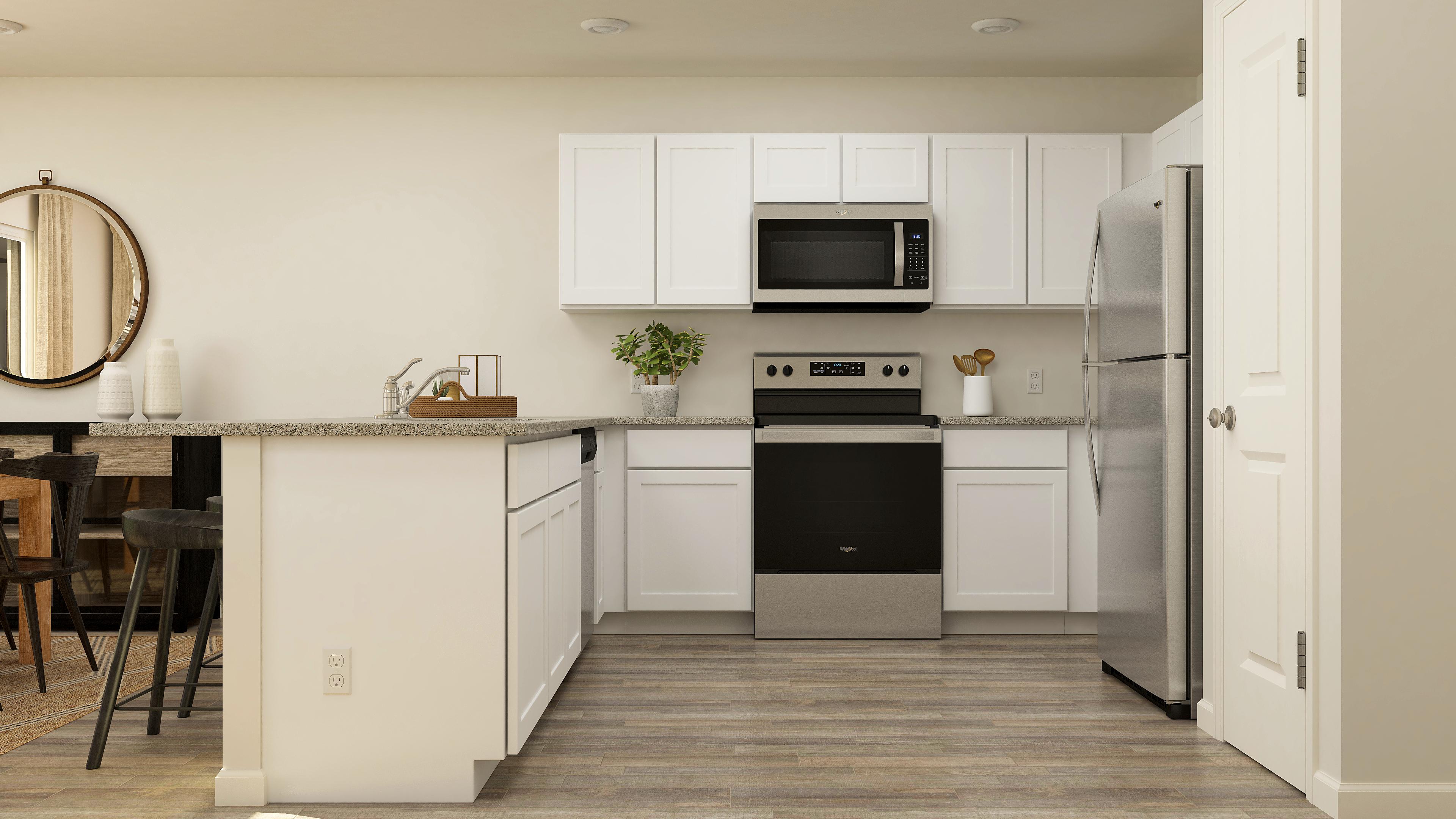 A kitchen with white cabinets.