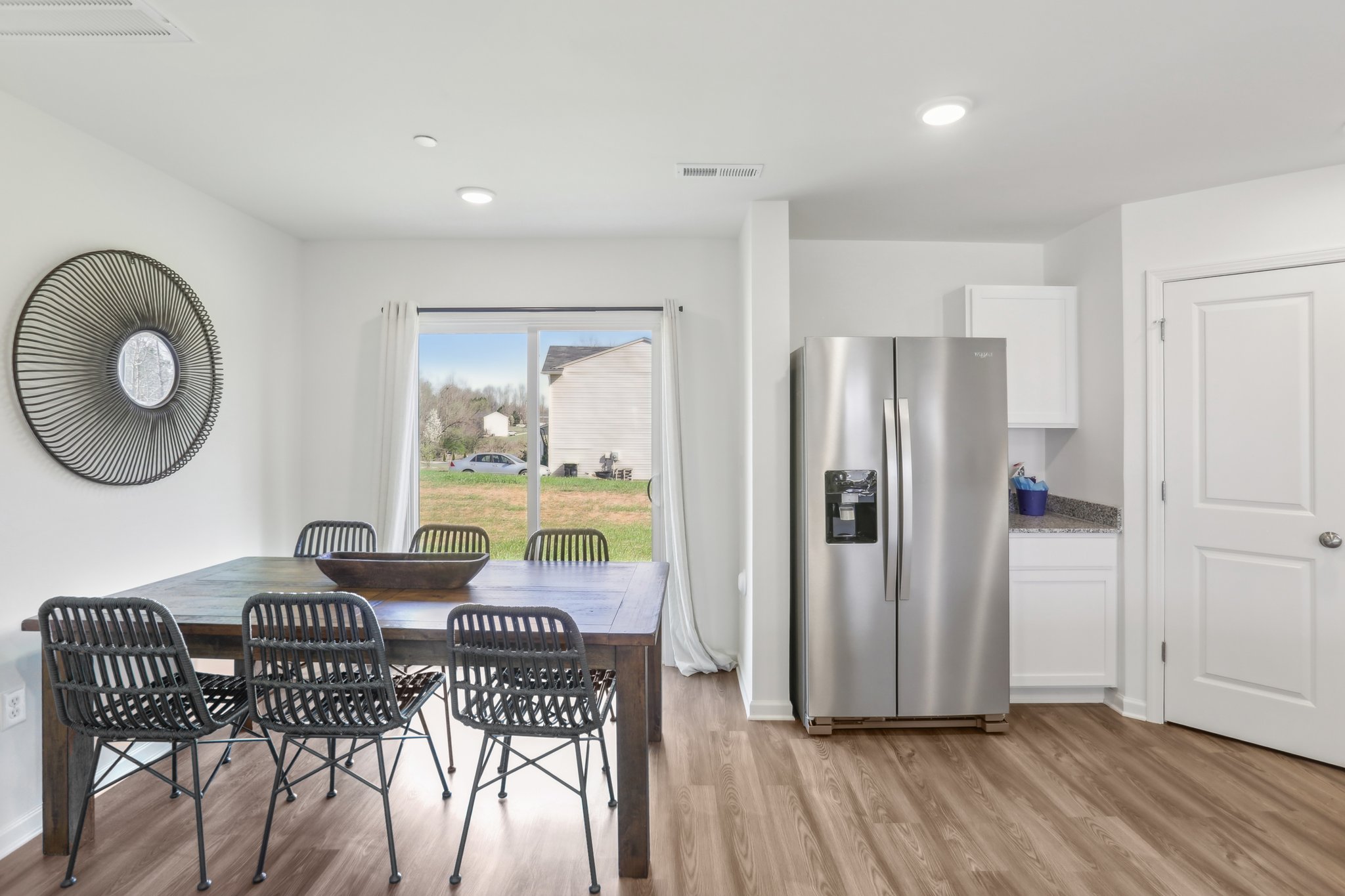 A kitchen with a table and chairs.