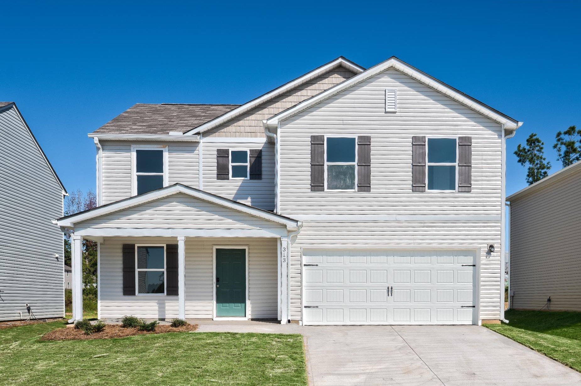 A white house with a garage.