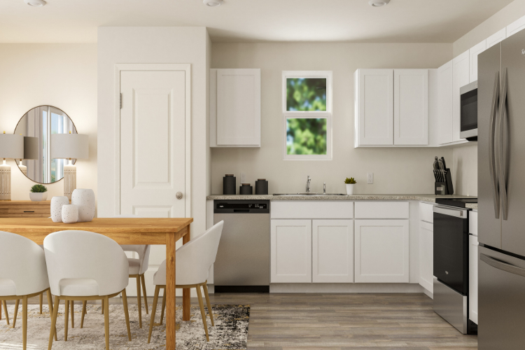 A kitchen with white cabinets.
